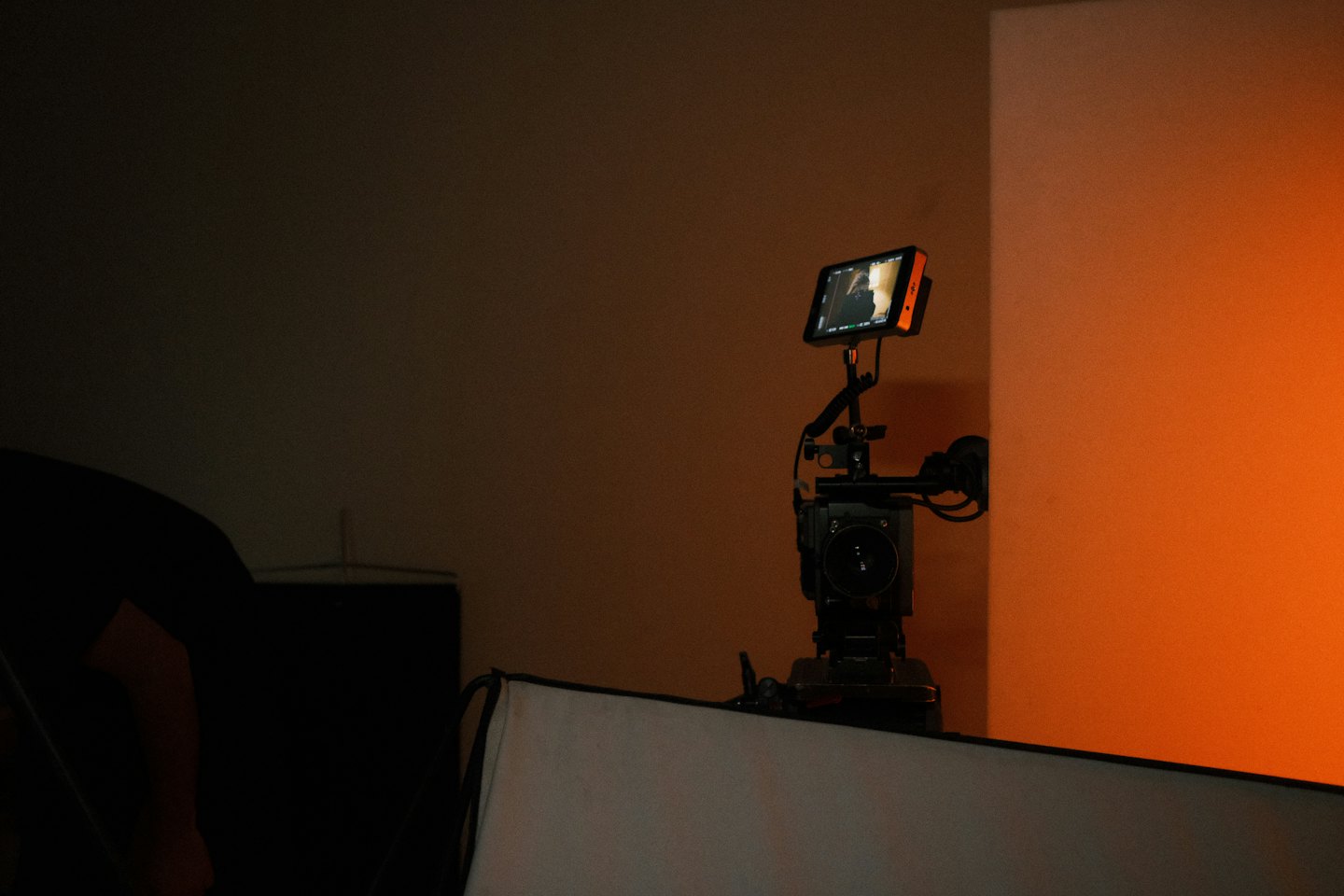 Professional video camera set up in an indoor studio.